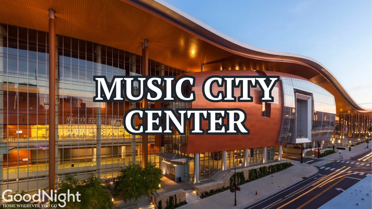 This image captures the iconic exterior of Music City Center, showcasing its distinctive curved roof architecture and surrounding landscaping. The building sits prominently in the downtown area, emphasizing the proximity to major event venues.