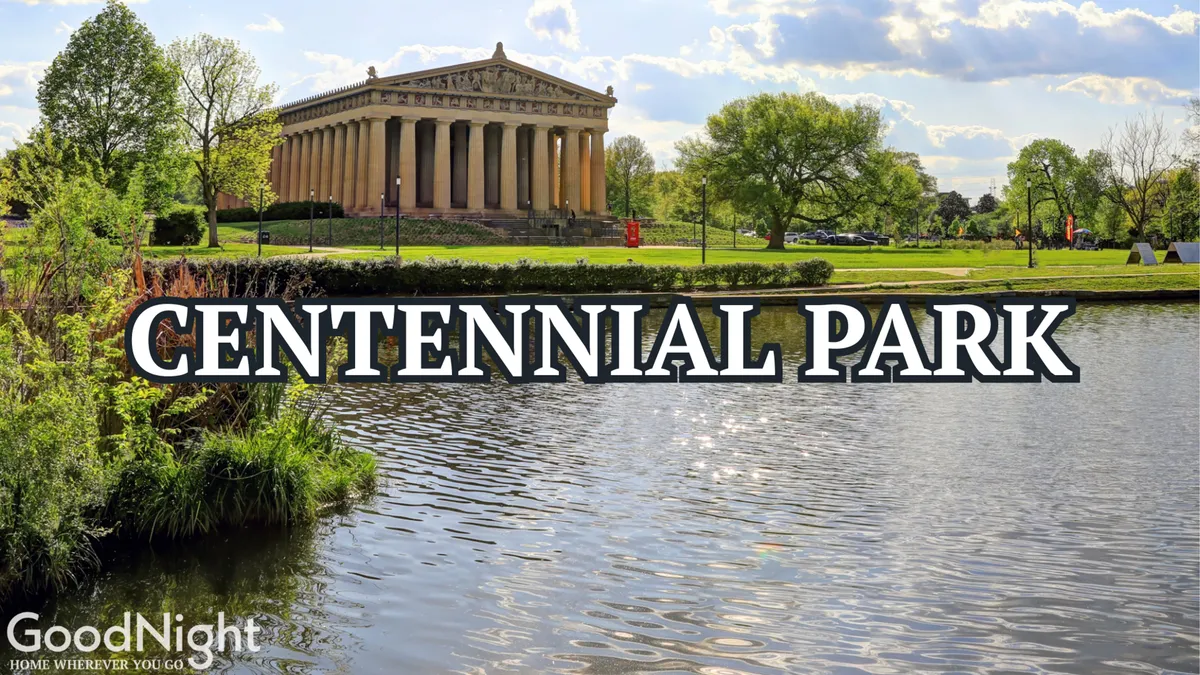 The iconic Parthenon stands majestically beside a reflective pond, surrounded by lush greenery in Centennial Park. The scene captures families and visitors enjoying the tranquil, cultural setting, ideal for picnics and leisurely strolls.