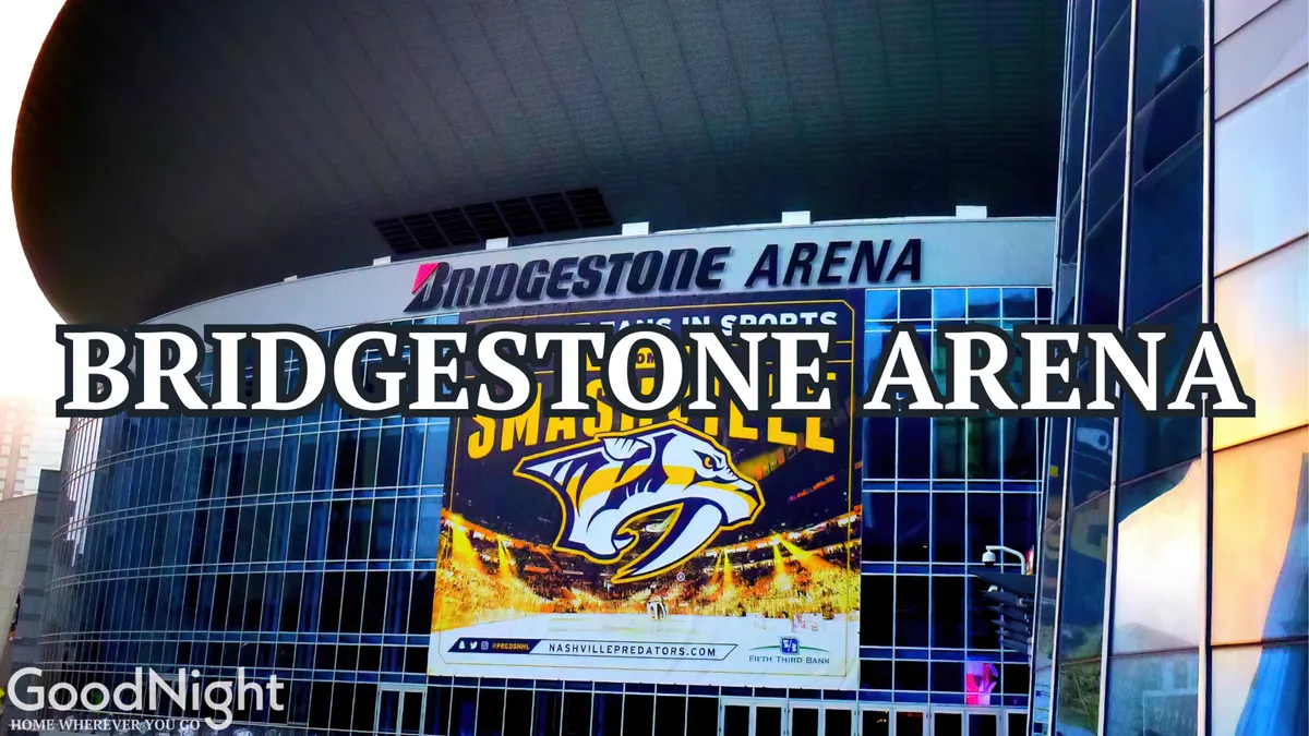 The image shows the prominent glass facade of Bridgestone Arena, with its recognizable sign and Nashville Predators banner. The urban setting and lively atmosphere are apparent, capturing the energy of an event venue at the heart of the city.